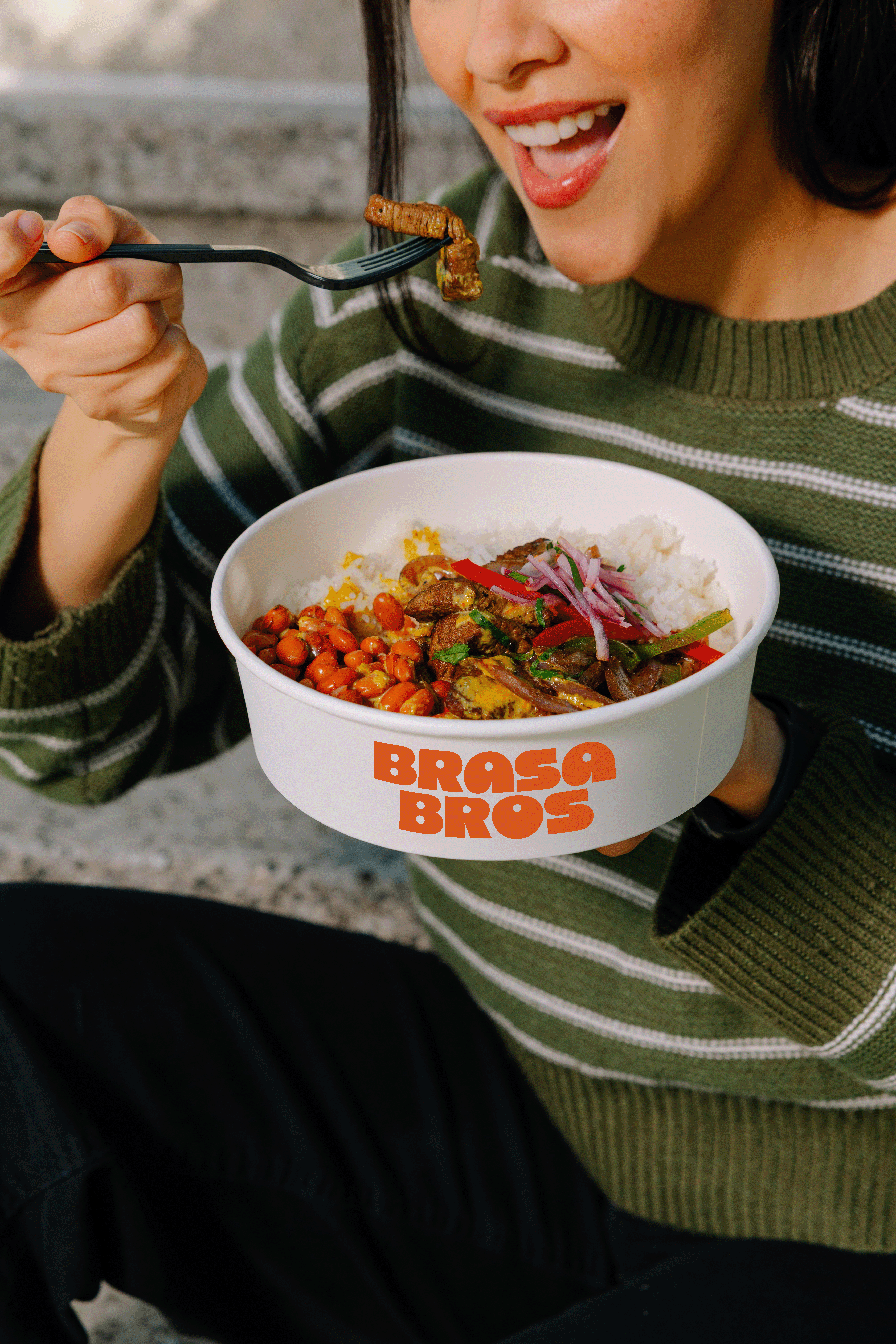 a person eating a bowl of food