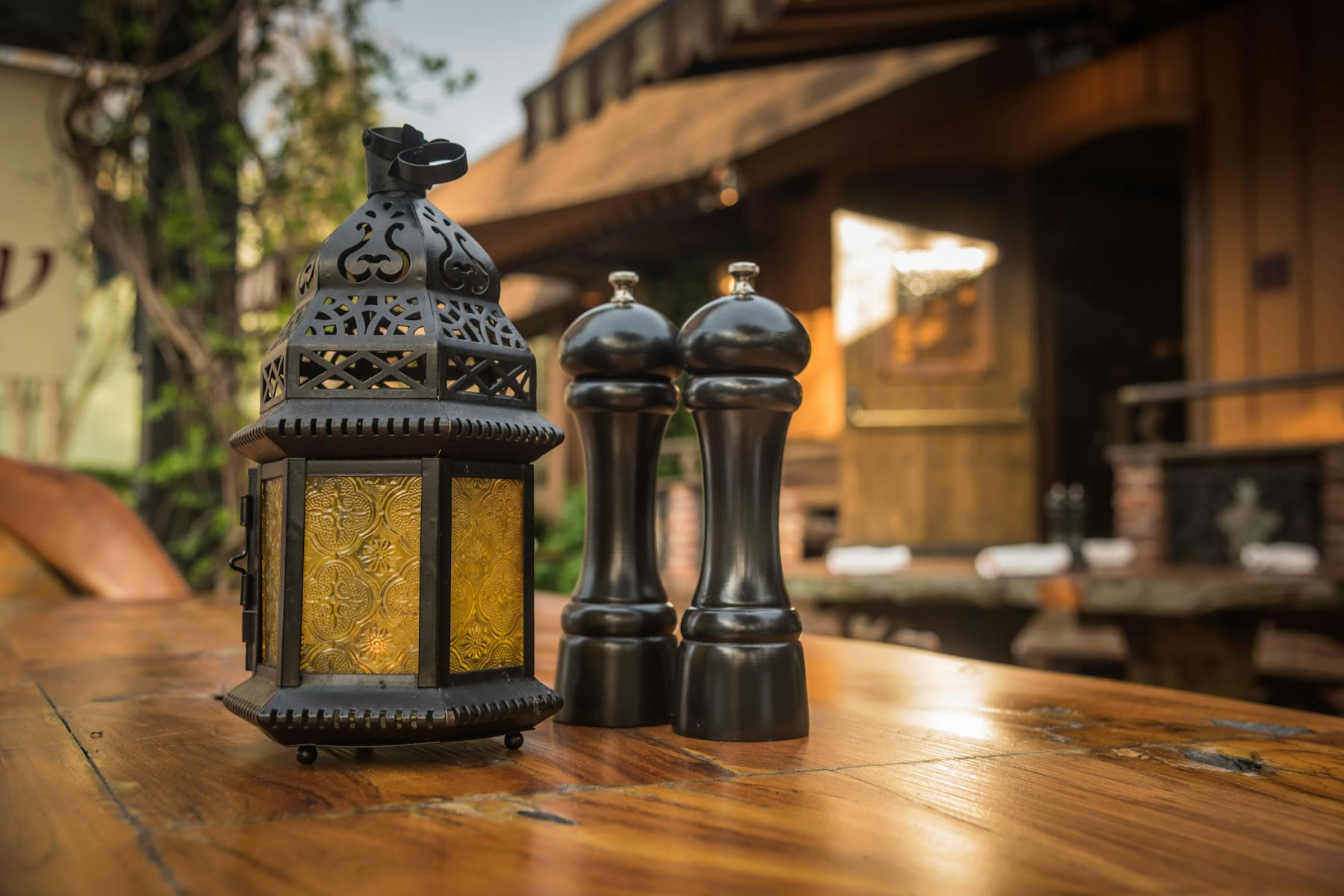 salt and pepper on a table with a lamp