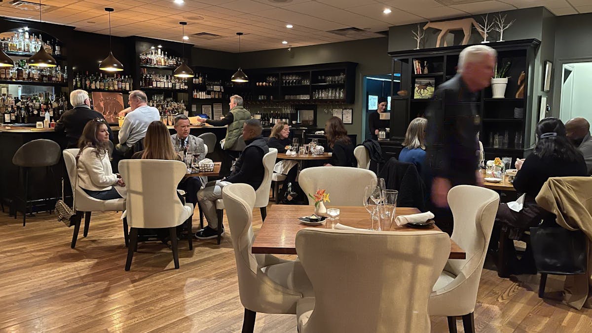 a group of people sitting at a table in a restaurant