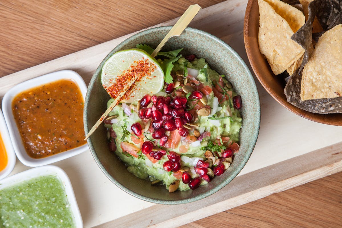 a bowl of food sitting on top of a wooden table