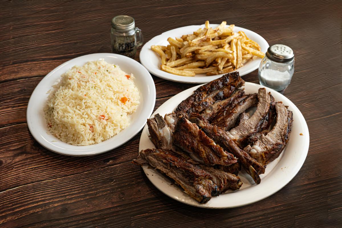 a plate of meat and rice on a table