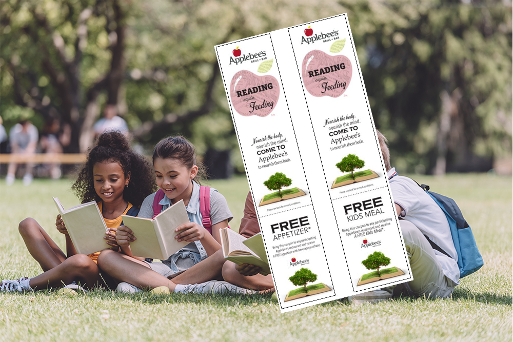 a group of people sitting on a bench reading a book