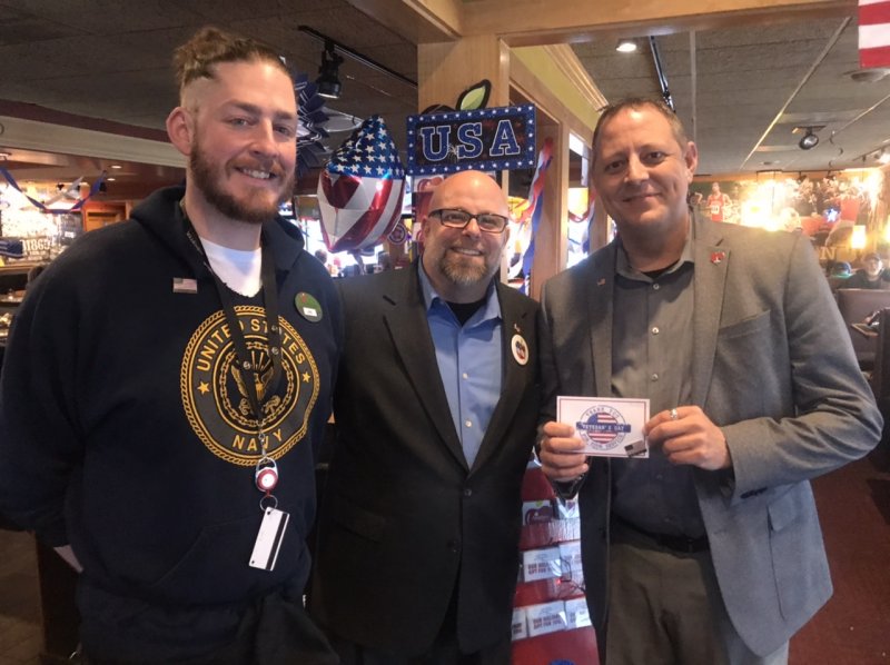 a man standing in front of a group of people posing for the camera