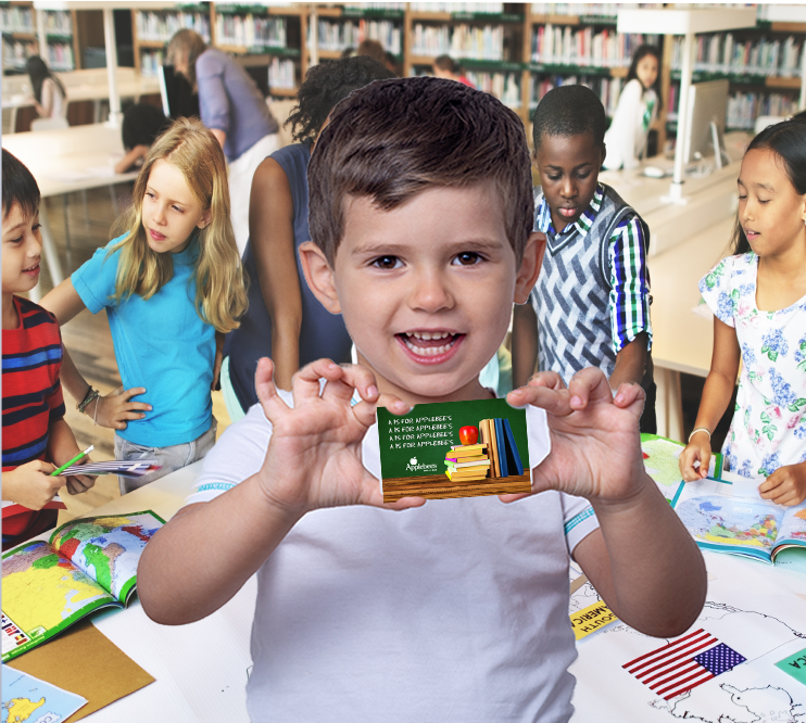 a young child holding a card