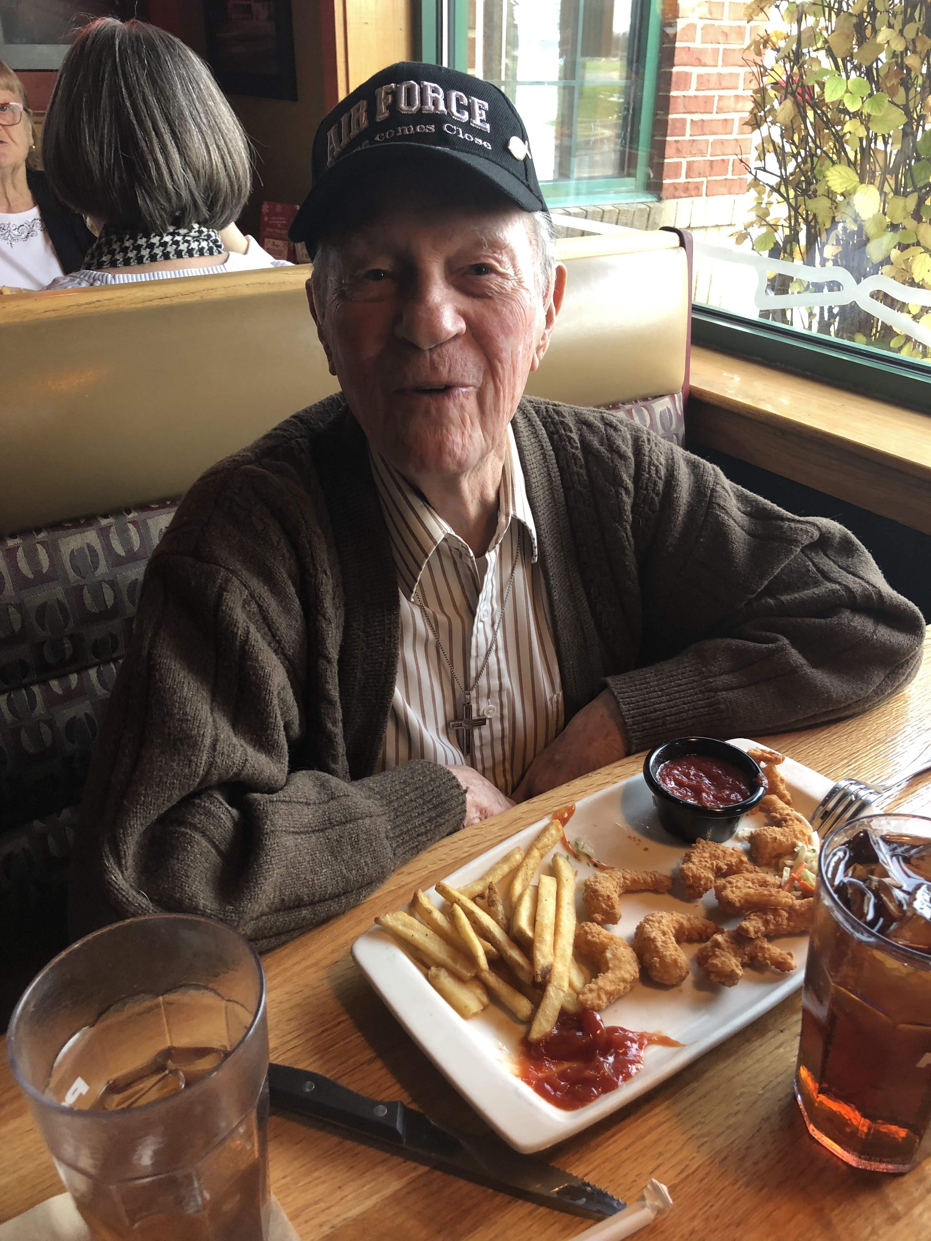 a person sitting at a table with a cup of coffee