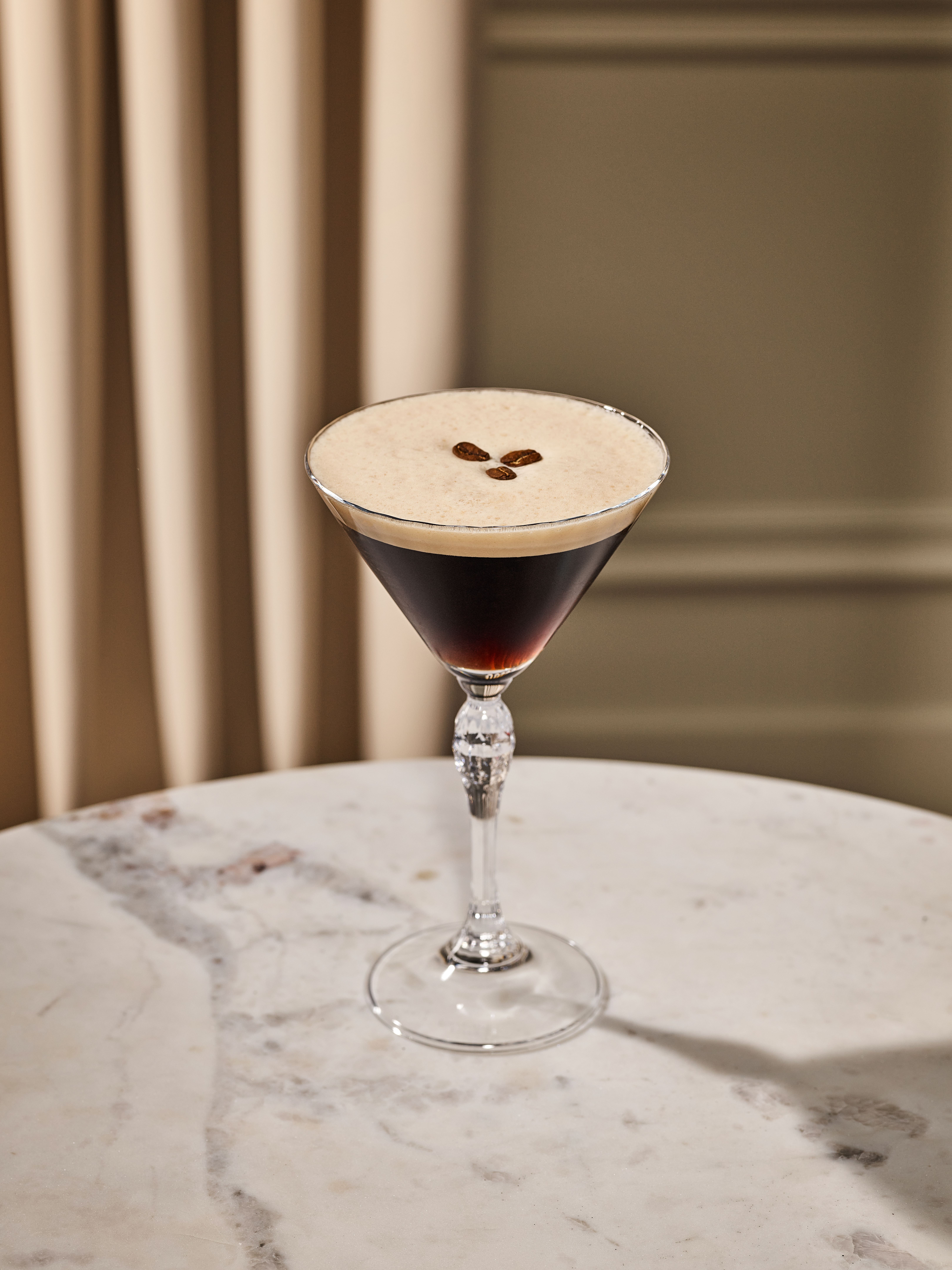 a glass of wine sitting on top of a table