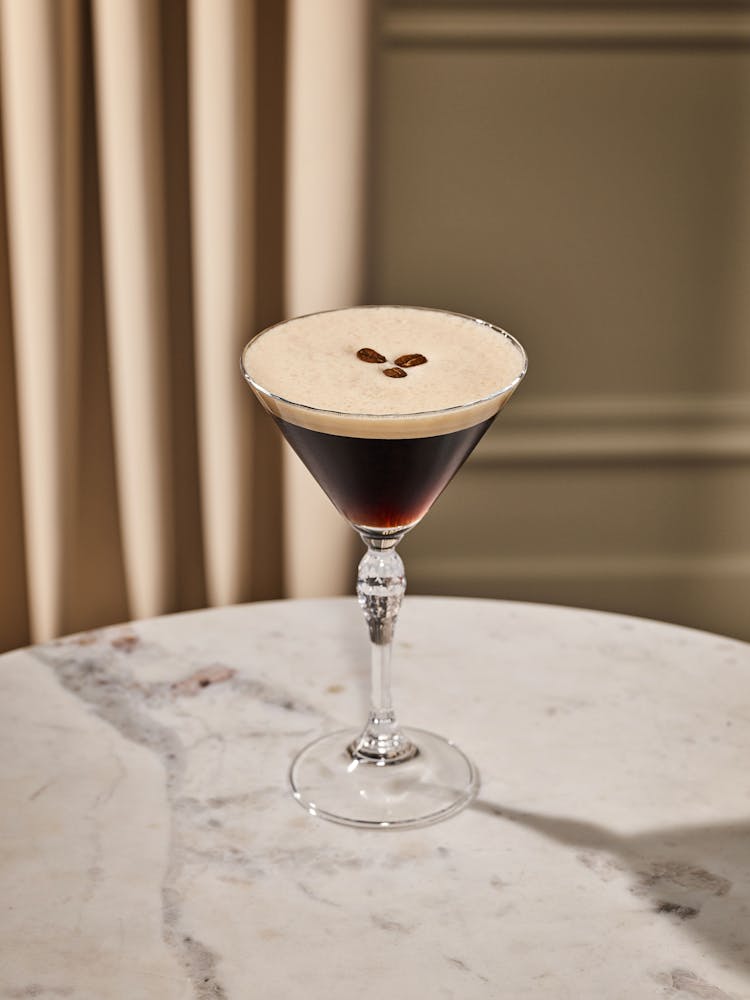 a glass of wine sitting on top of a table