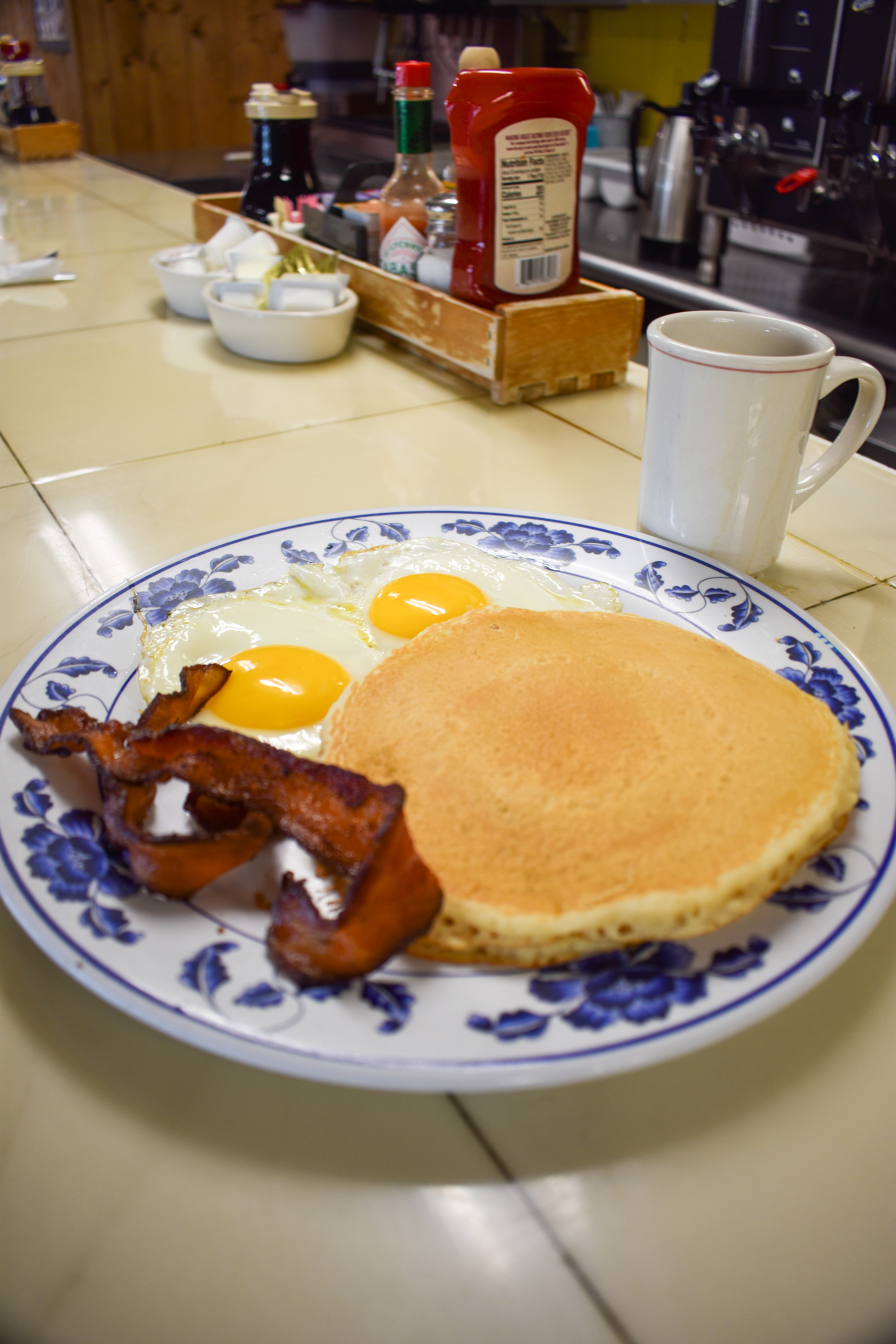 a plate of food and a cup of coffee