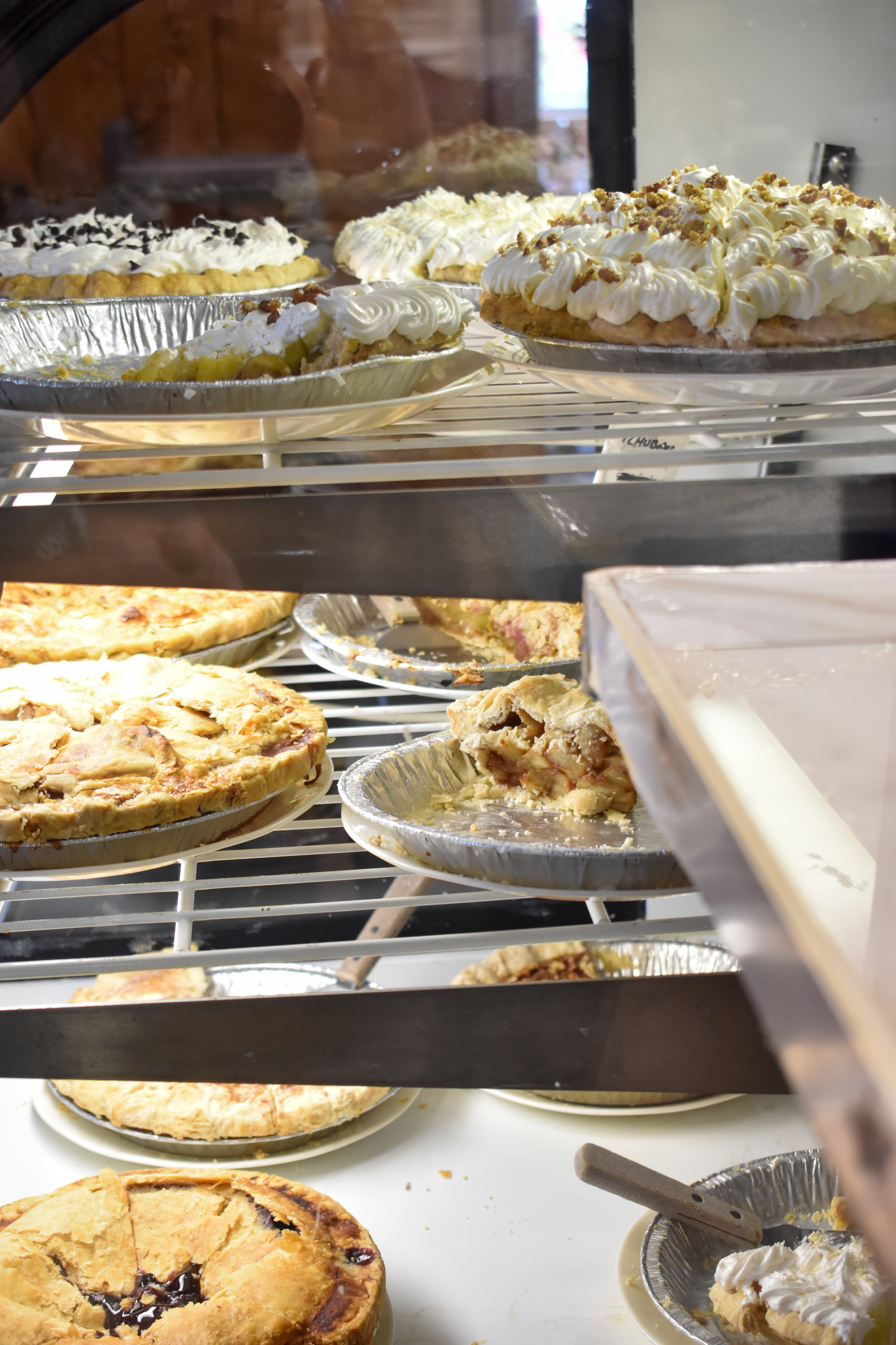 a glass display case with many different types of food