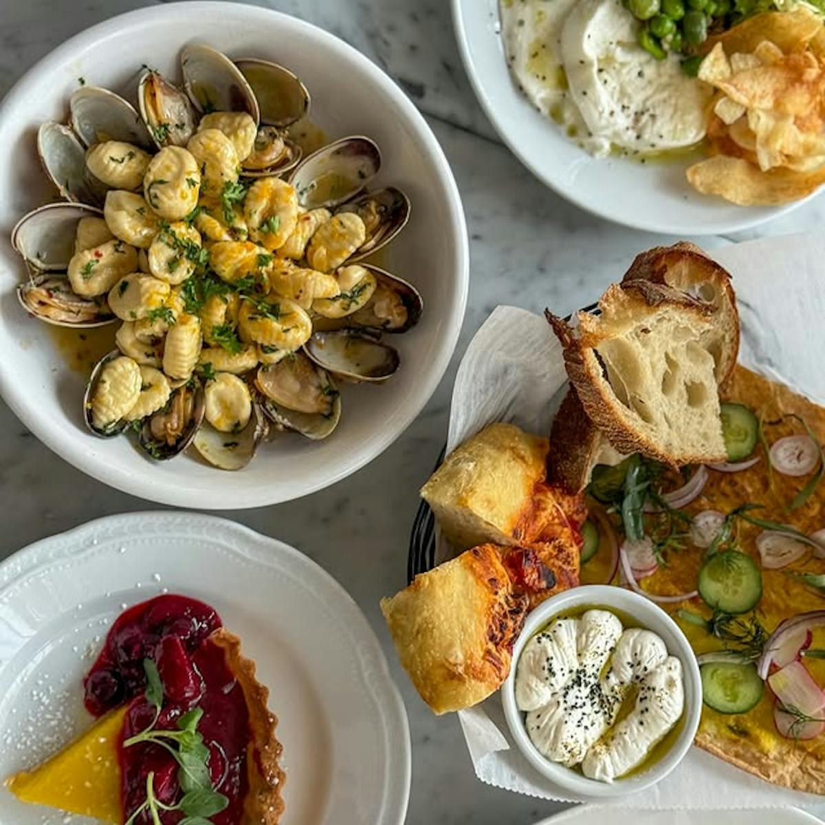 various Italian dishes, pasta, clams, bread, sauce, cheeses