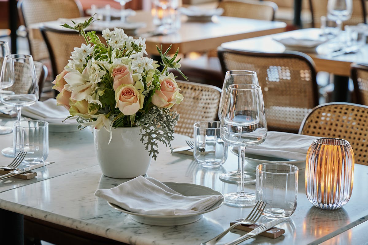 a vase of flowers on a dining table