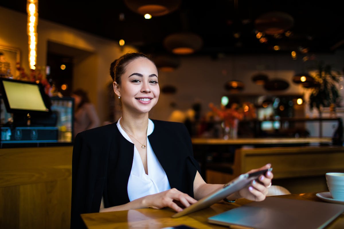 a hostess sitting at stand