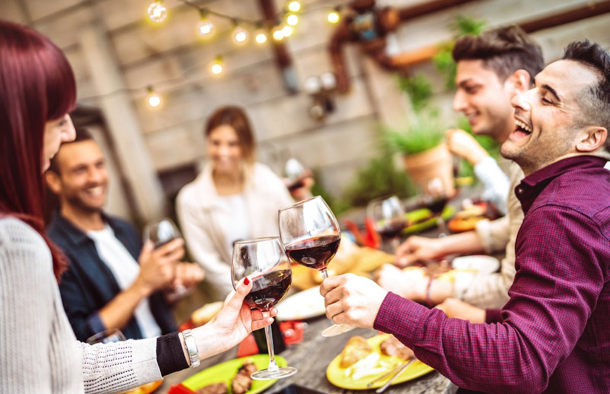 a group of people holding wine glasses