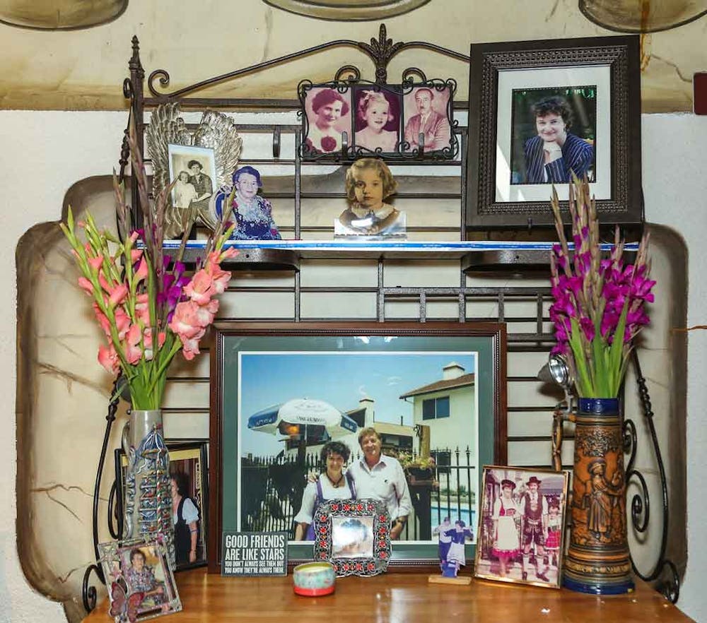 a desk with a vase of flowers on a table