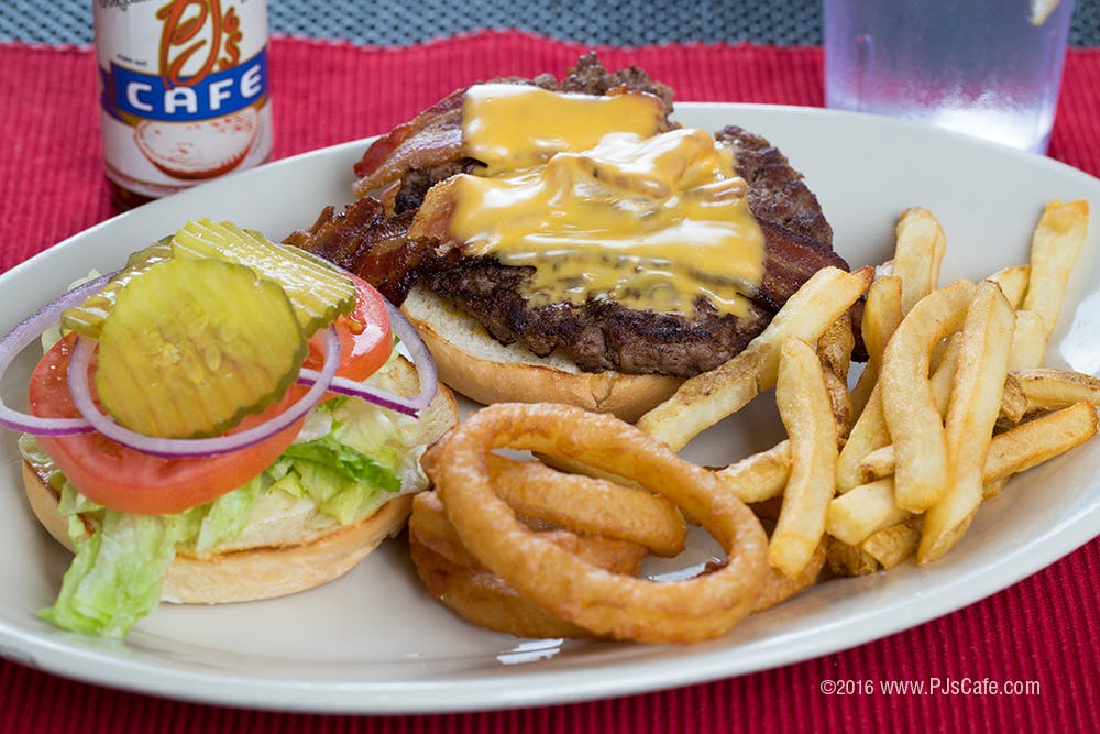 a white plate topped with a sandwich and fries on a table