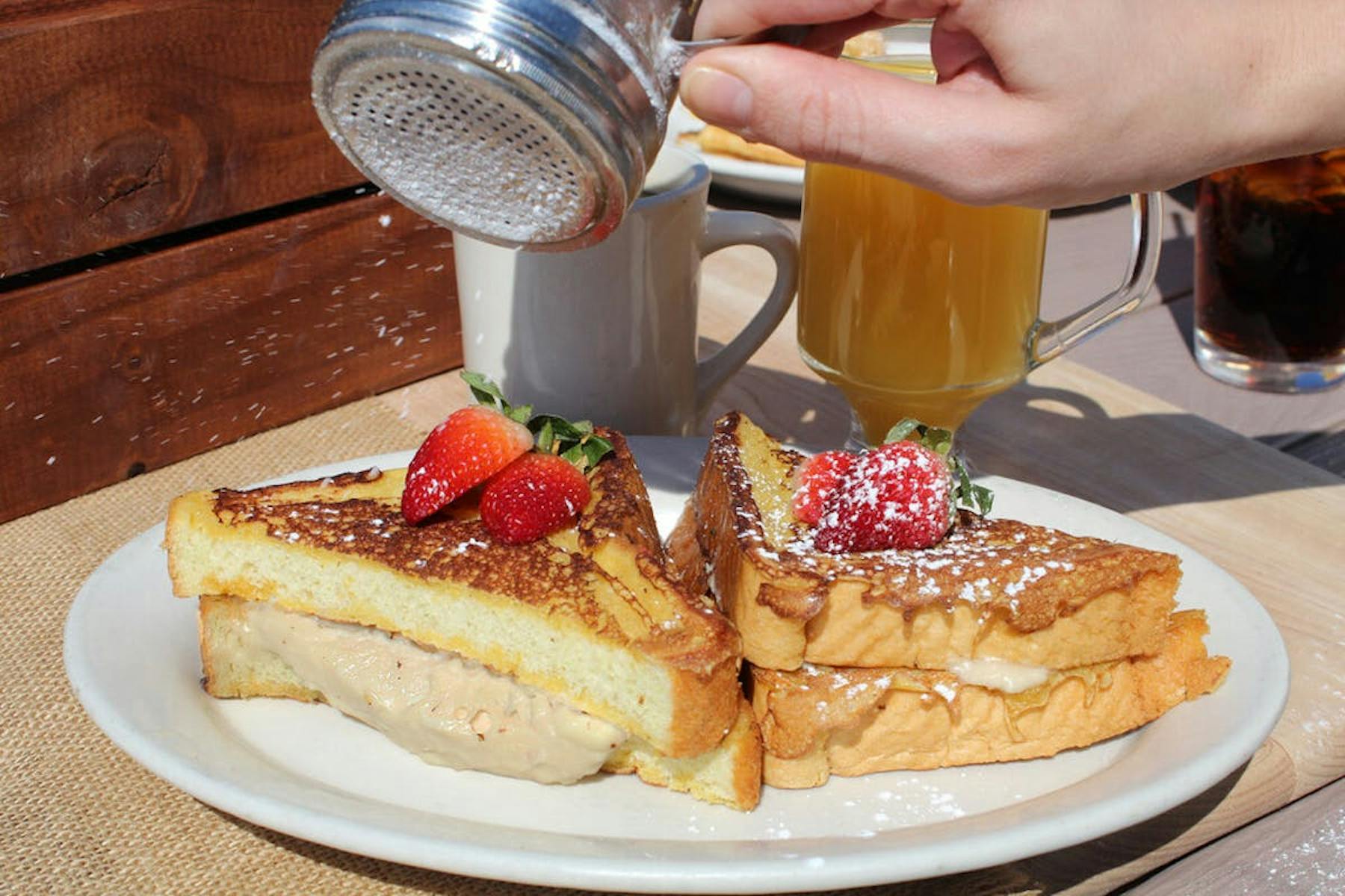 a plate of food with a sandwich and a cup of coffee