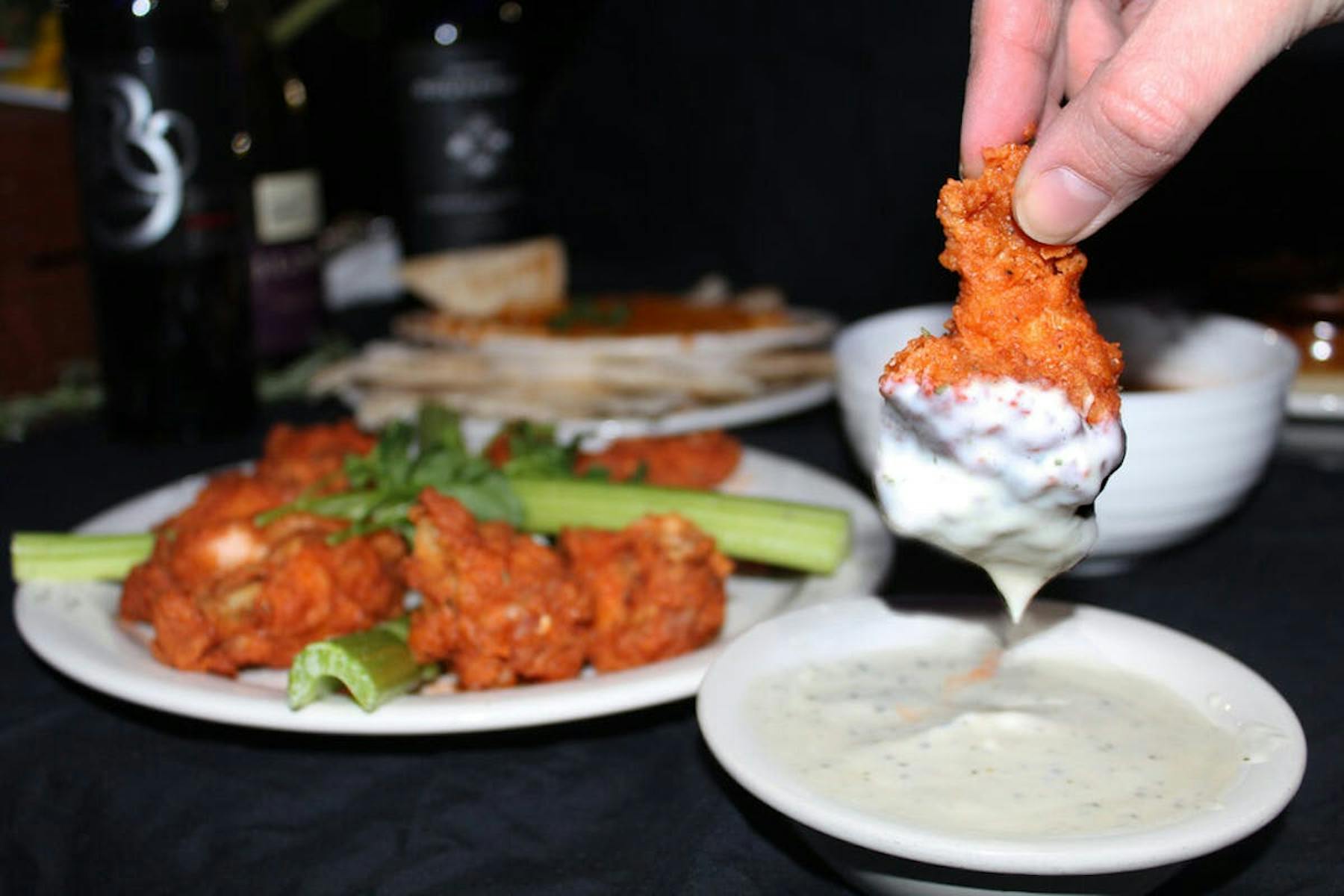 a close up of a person holding a plate of food on a table