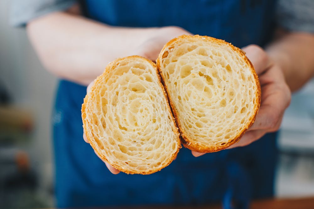 a close up of a person holding a donut