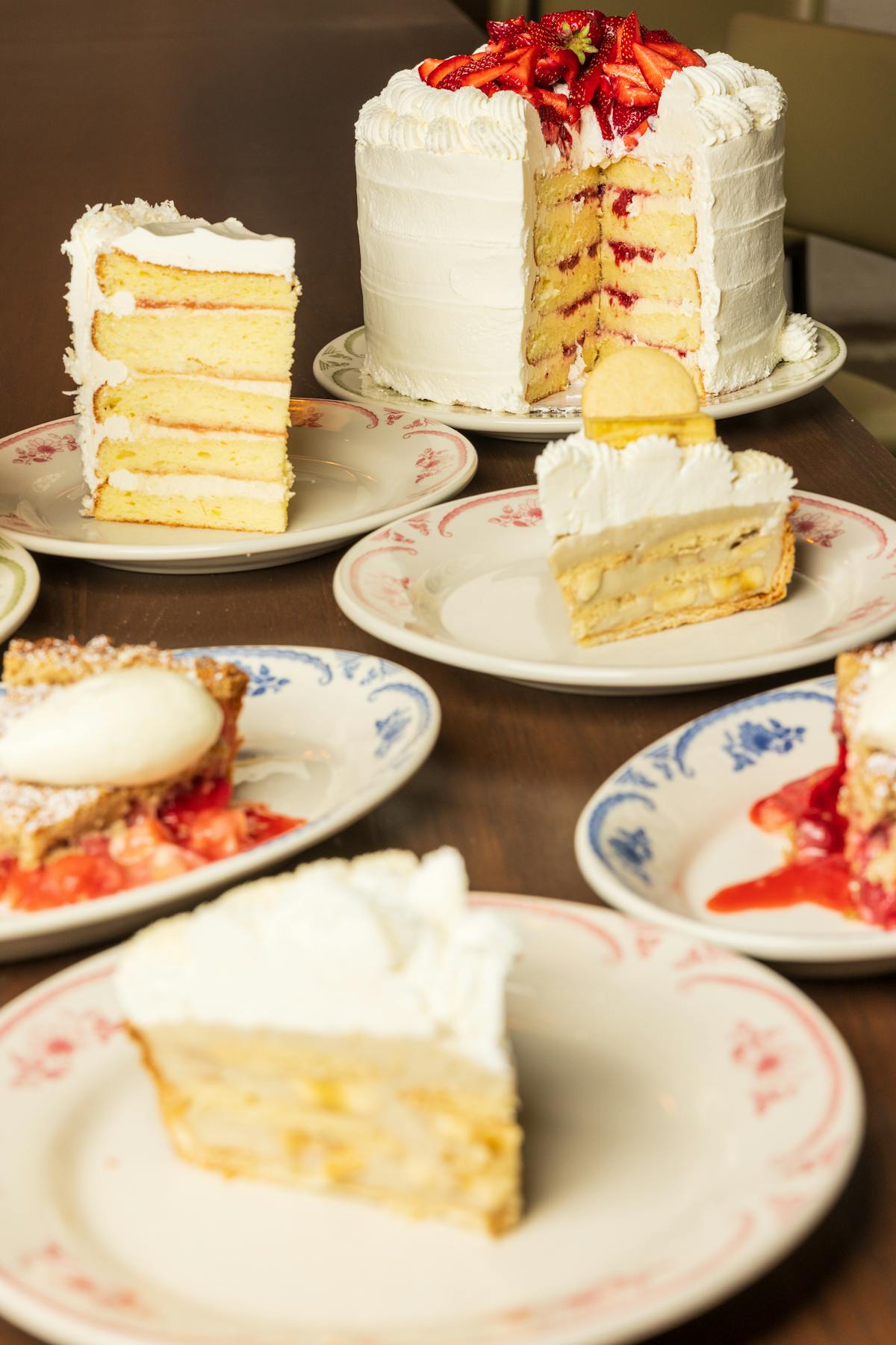 a plate of food with a slice of cake on a table