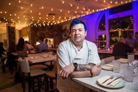 a man sitting at a table in a restaurant