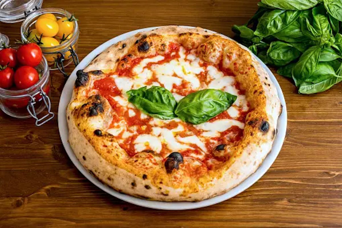 a pizza sitting on top of a wooden table