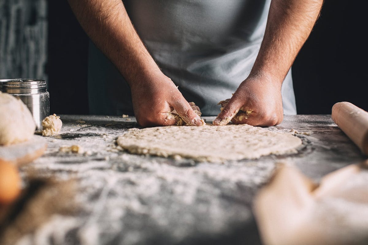 a close up of a man cutting food on a table