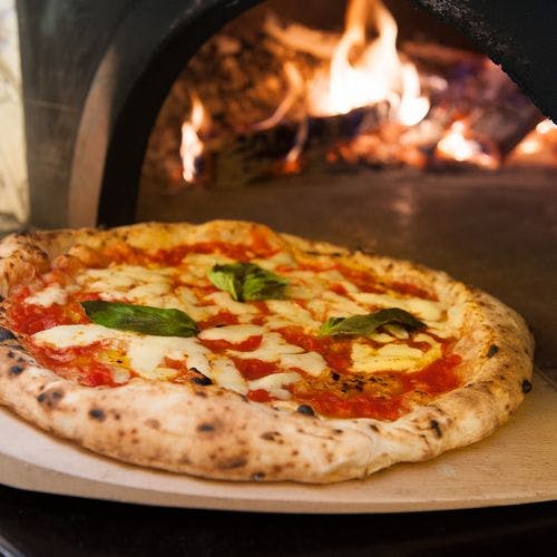 a pizza sitting on top of a pan on a stove