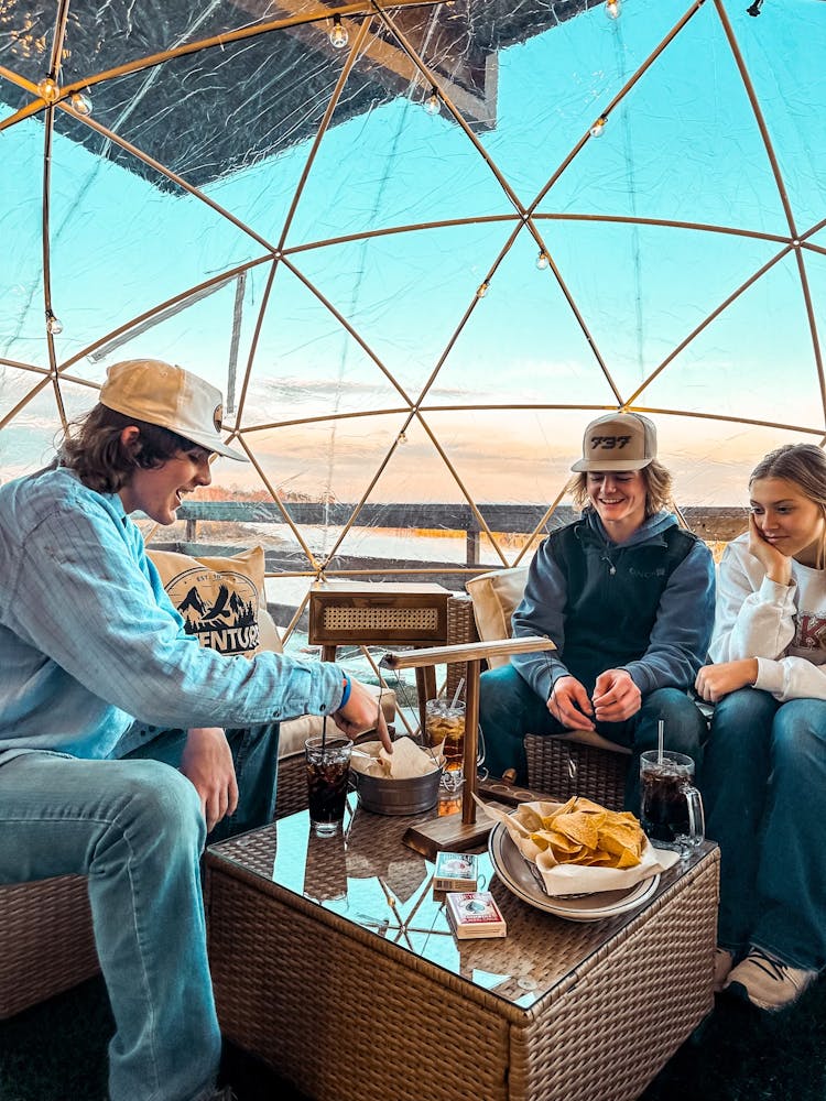 a group of people in a Captain John's patio igloo 