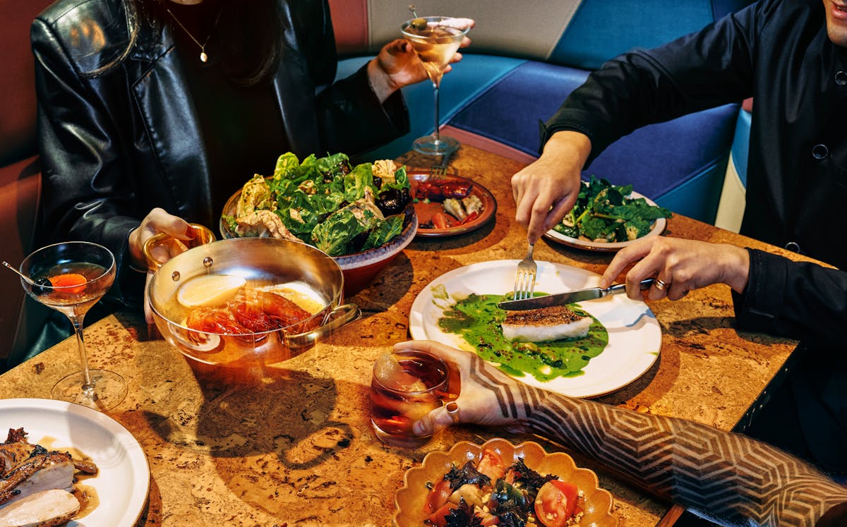 a person sitting at a table with a plate of food