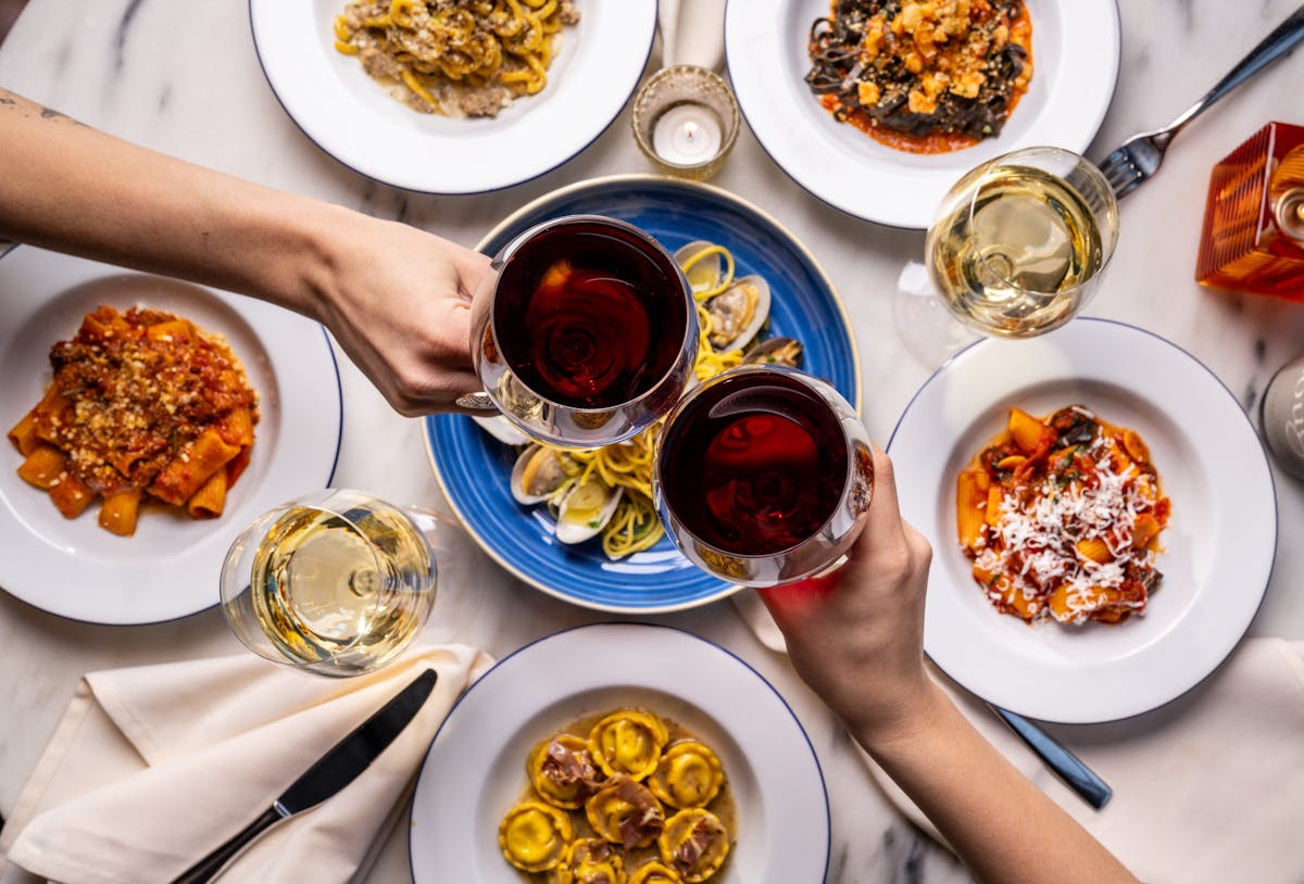 a group of people sitting at a table with a plate of food