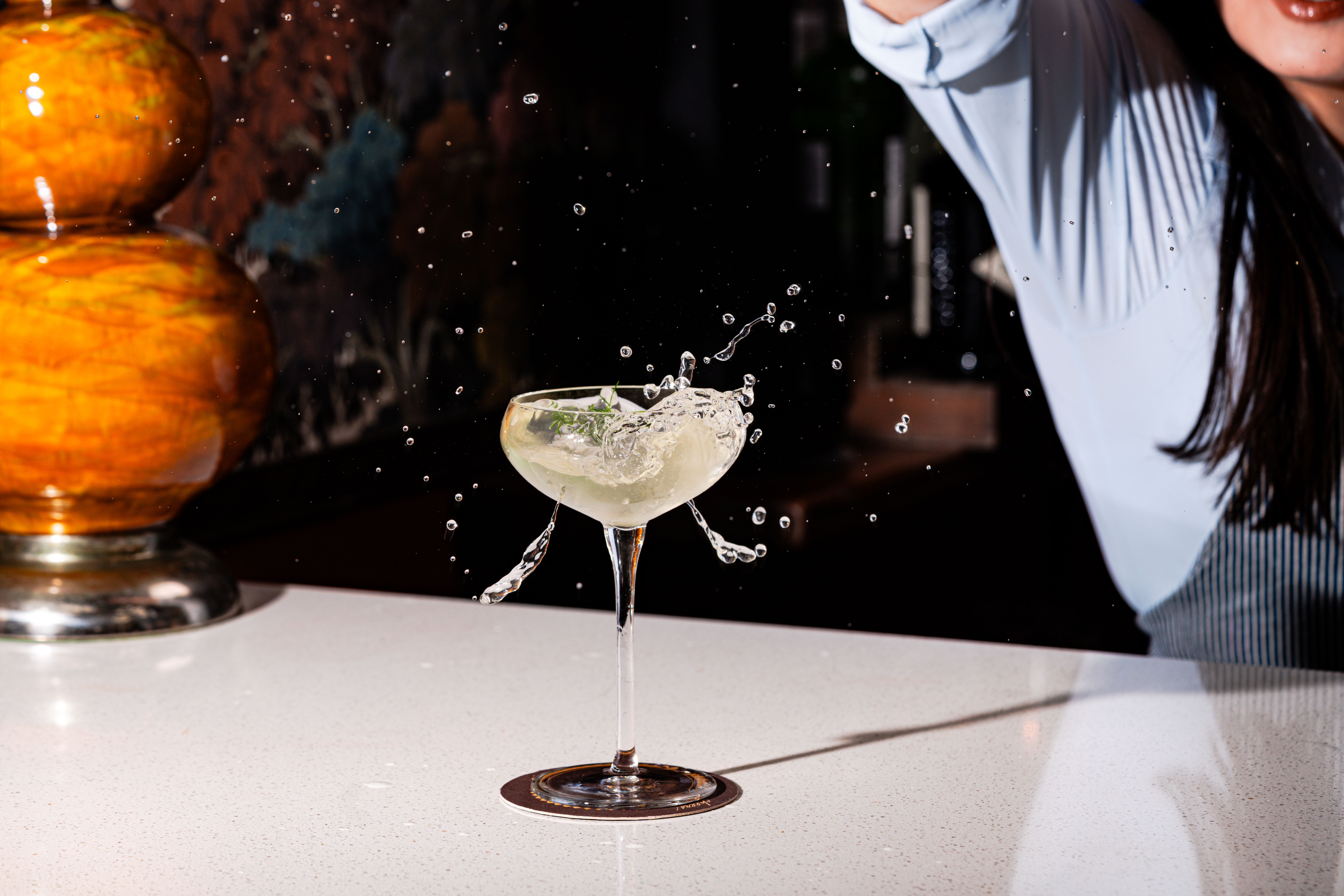 a glass with liquid splashing out of it