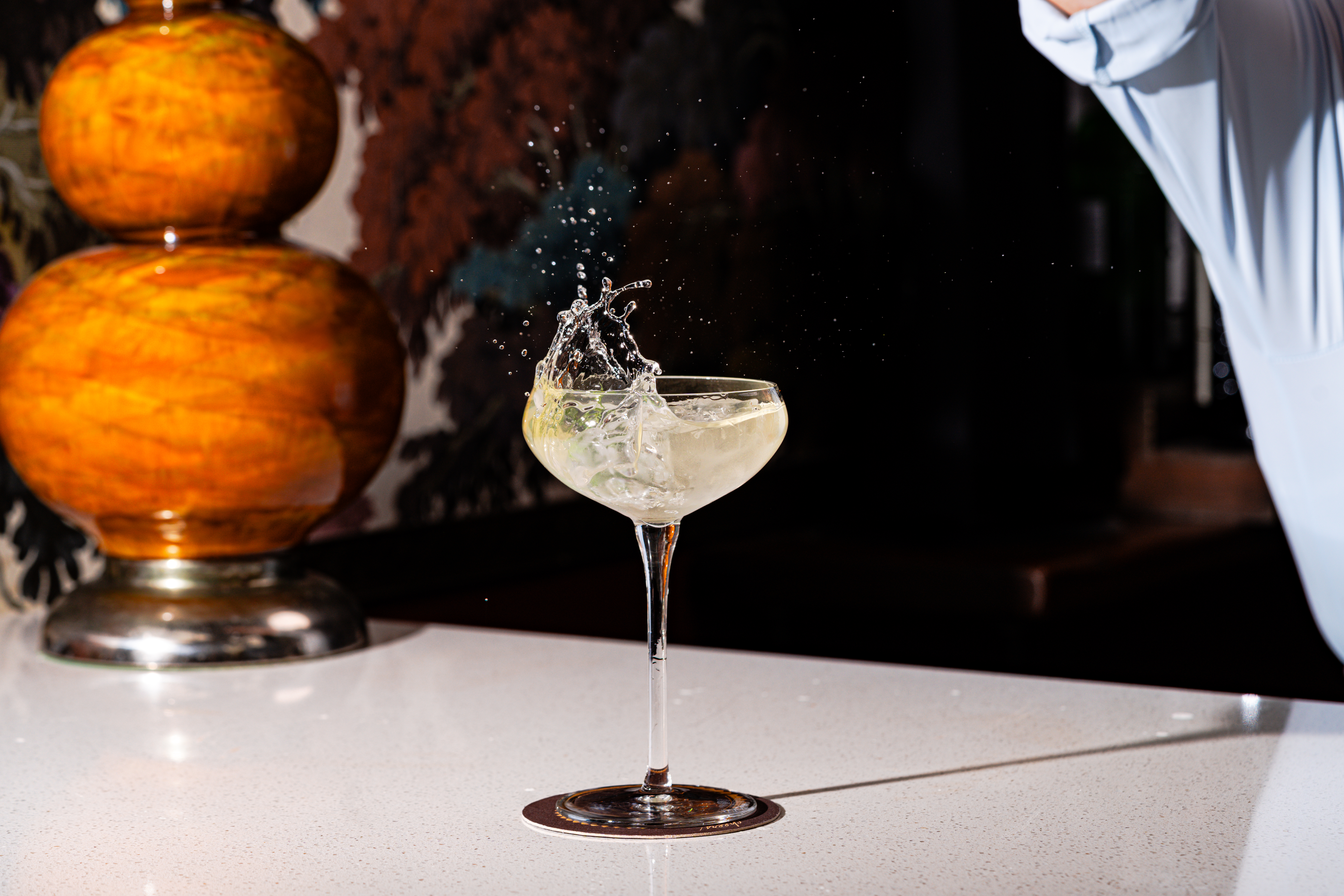 a glass with liquid splashing out of it