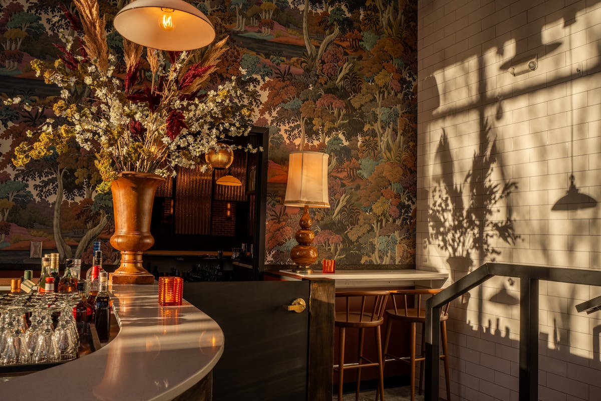 a room filled with furniture and vase of flowers on a table