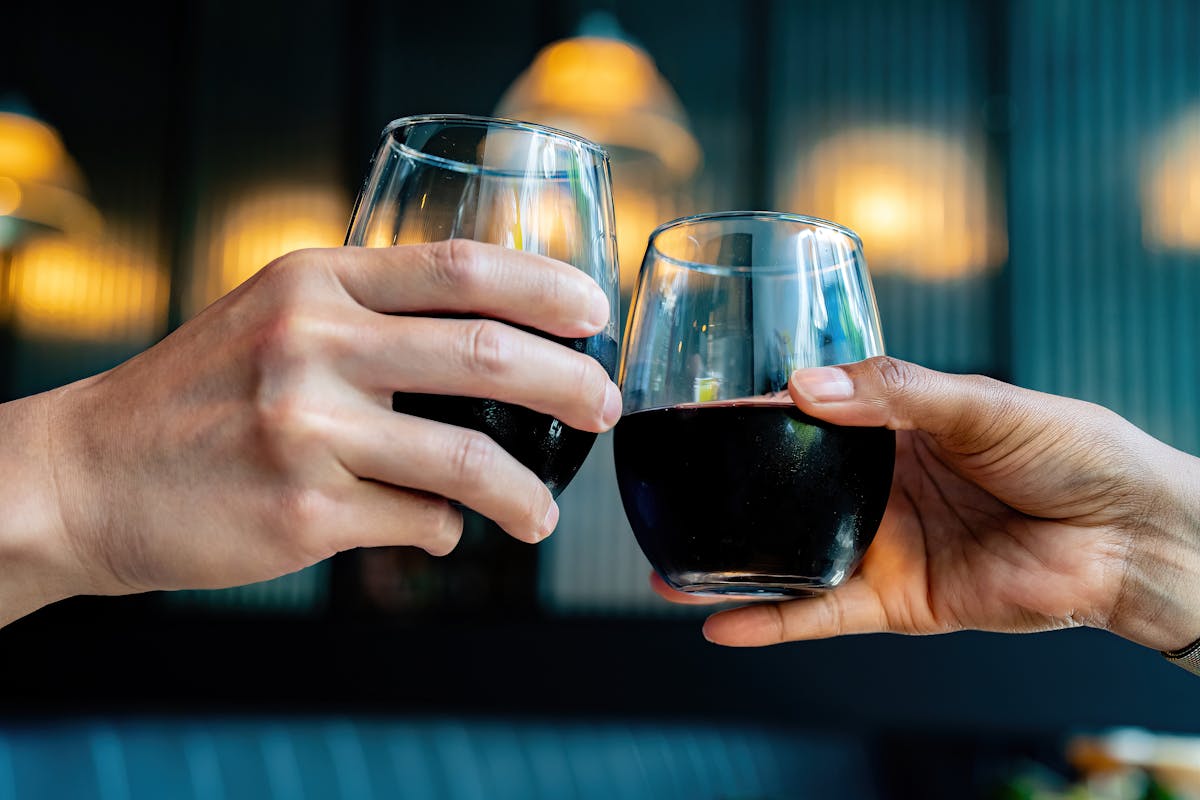 a hand holding a glass of wine