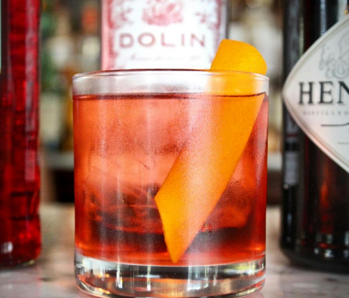 a glass of negroni on a table