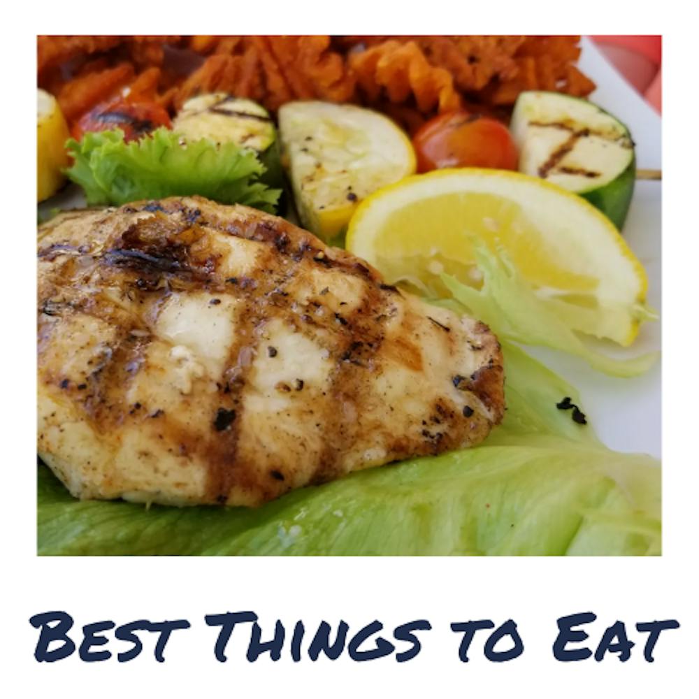 a sign in front of a palm tree