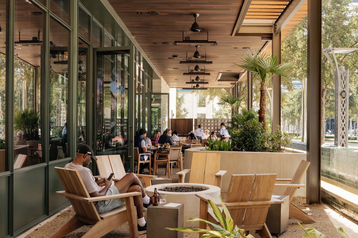 a living room filled with furniture and vase of flowers on a table