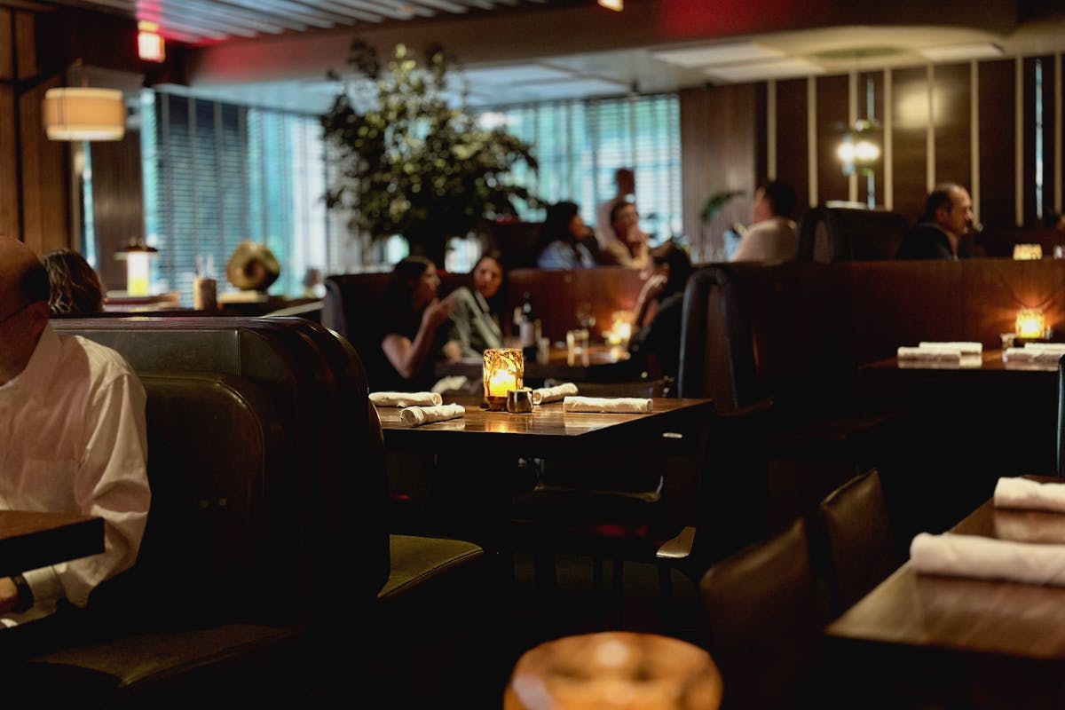 a group of people sitting at a table in a restaurant