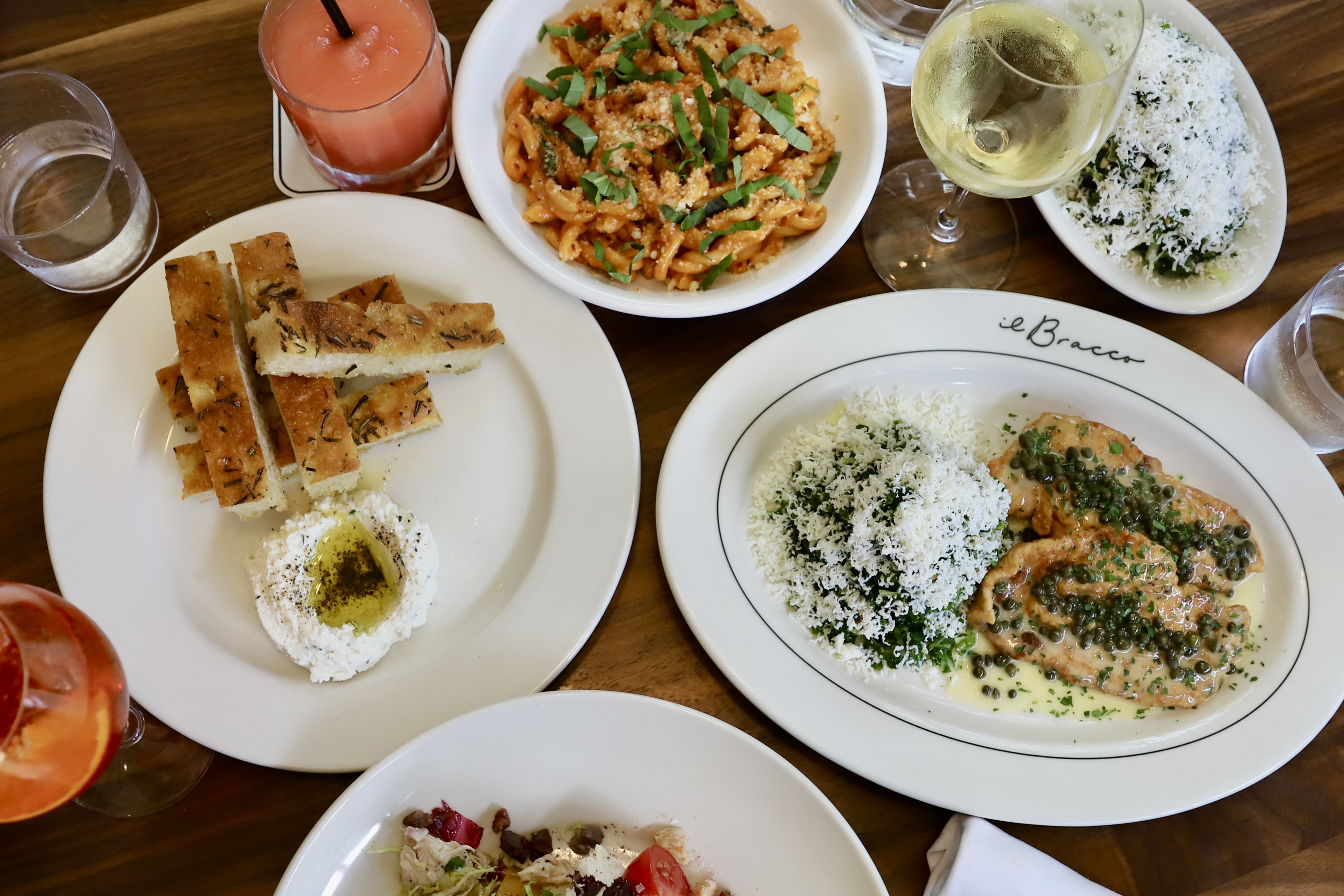 a group of people sitting at a table with a plate of food