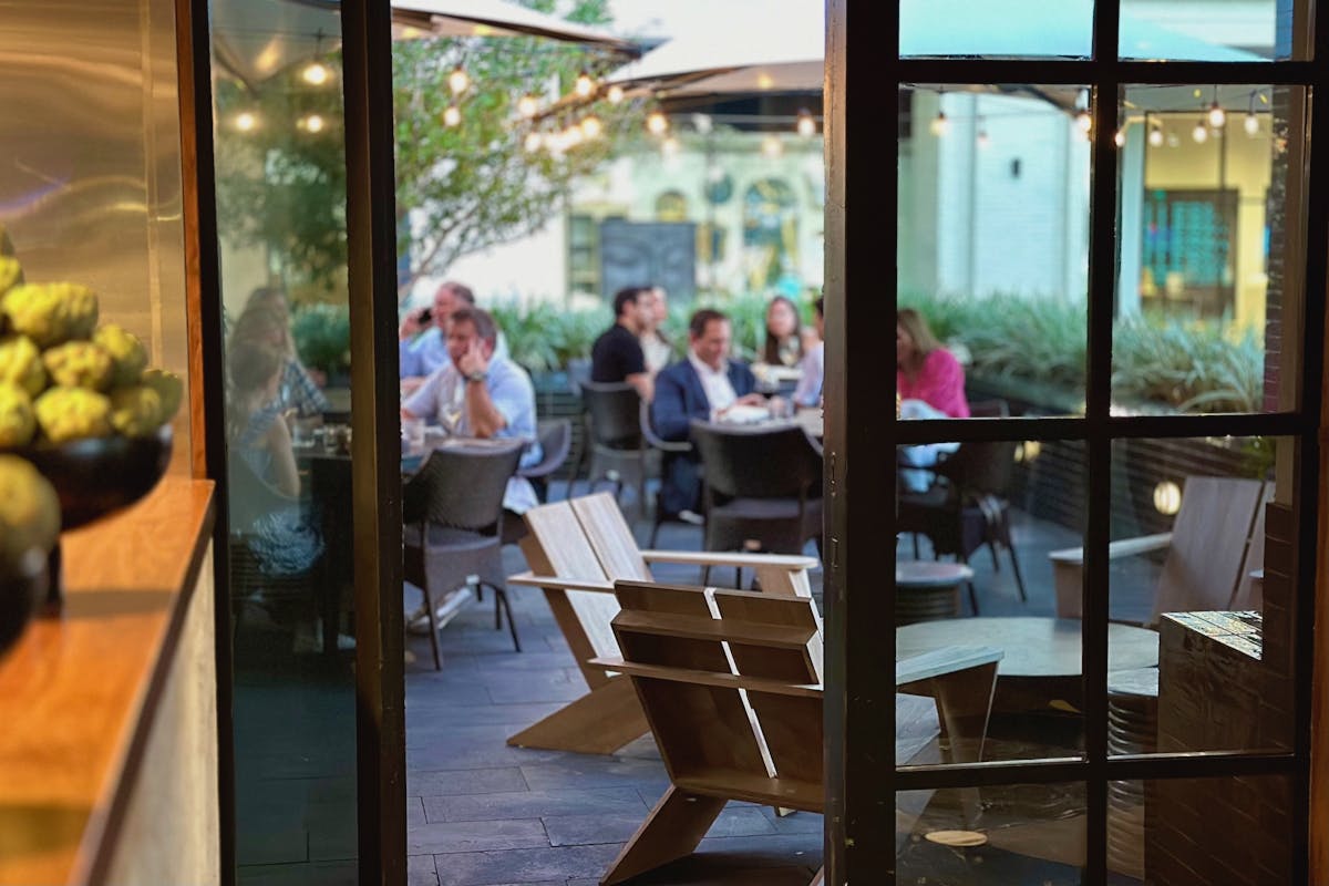 a person sitting at a table in front of a window
