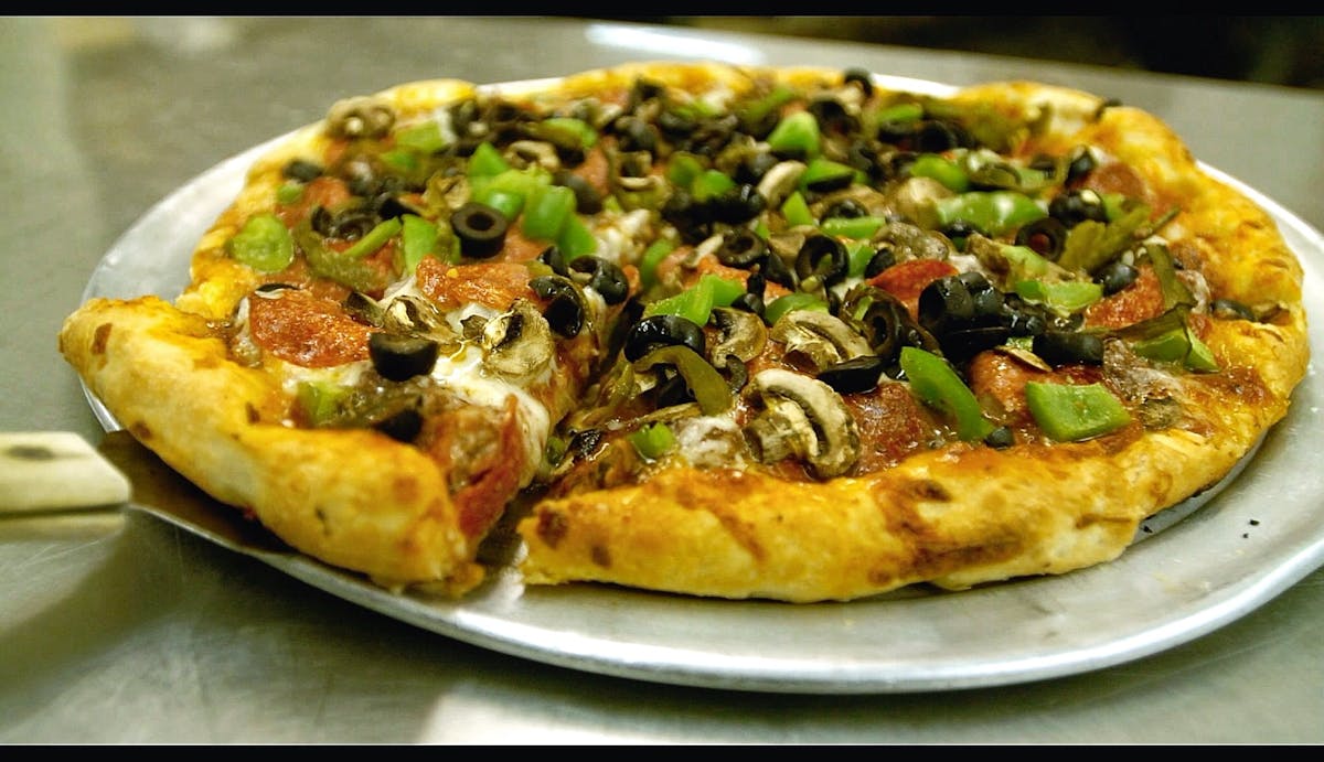 a pizza sitting on top of a plate of food