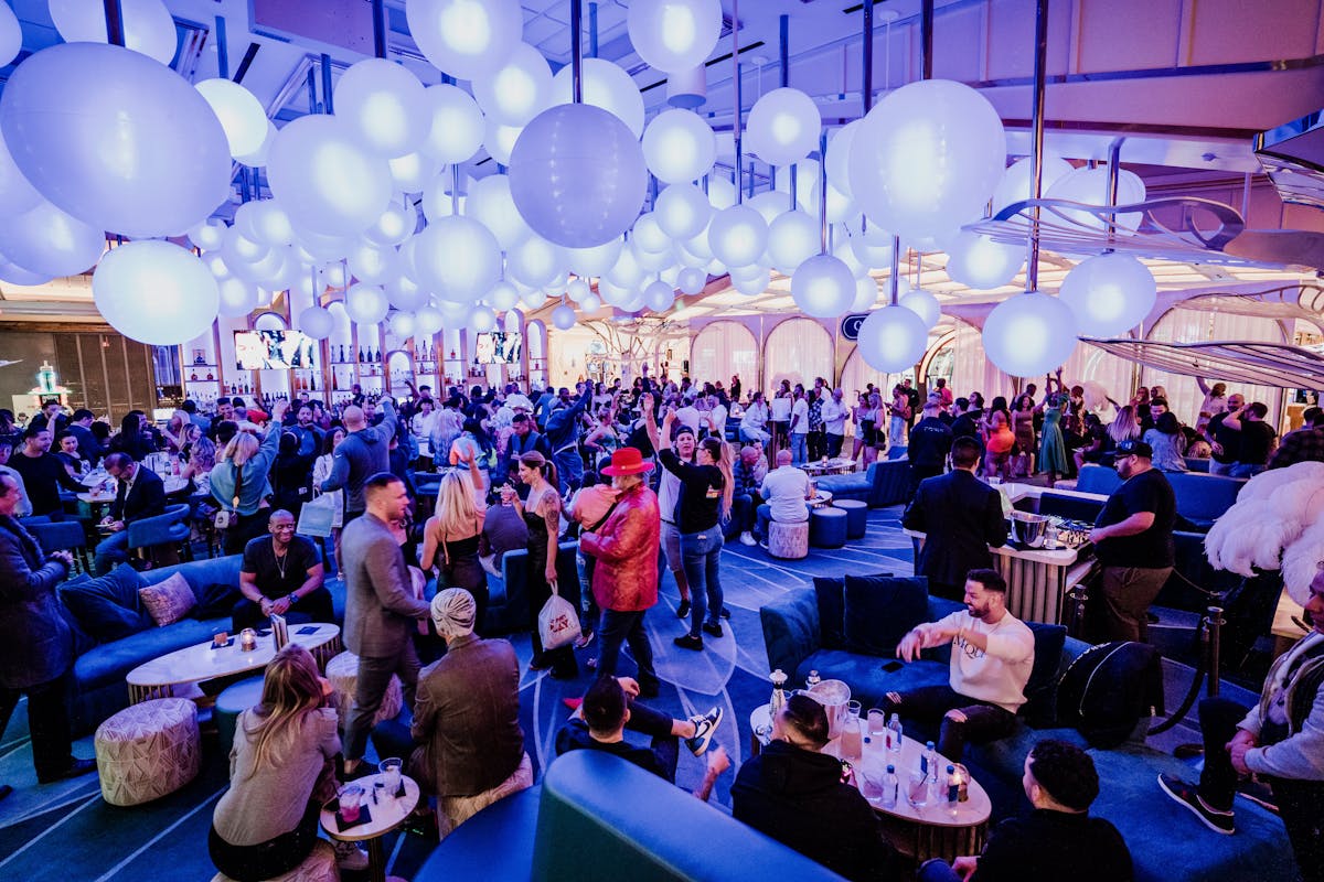 a group of people sitting at a table in front of a crowd