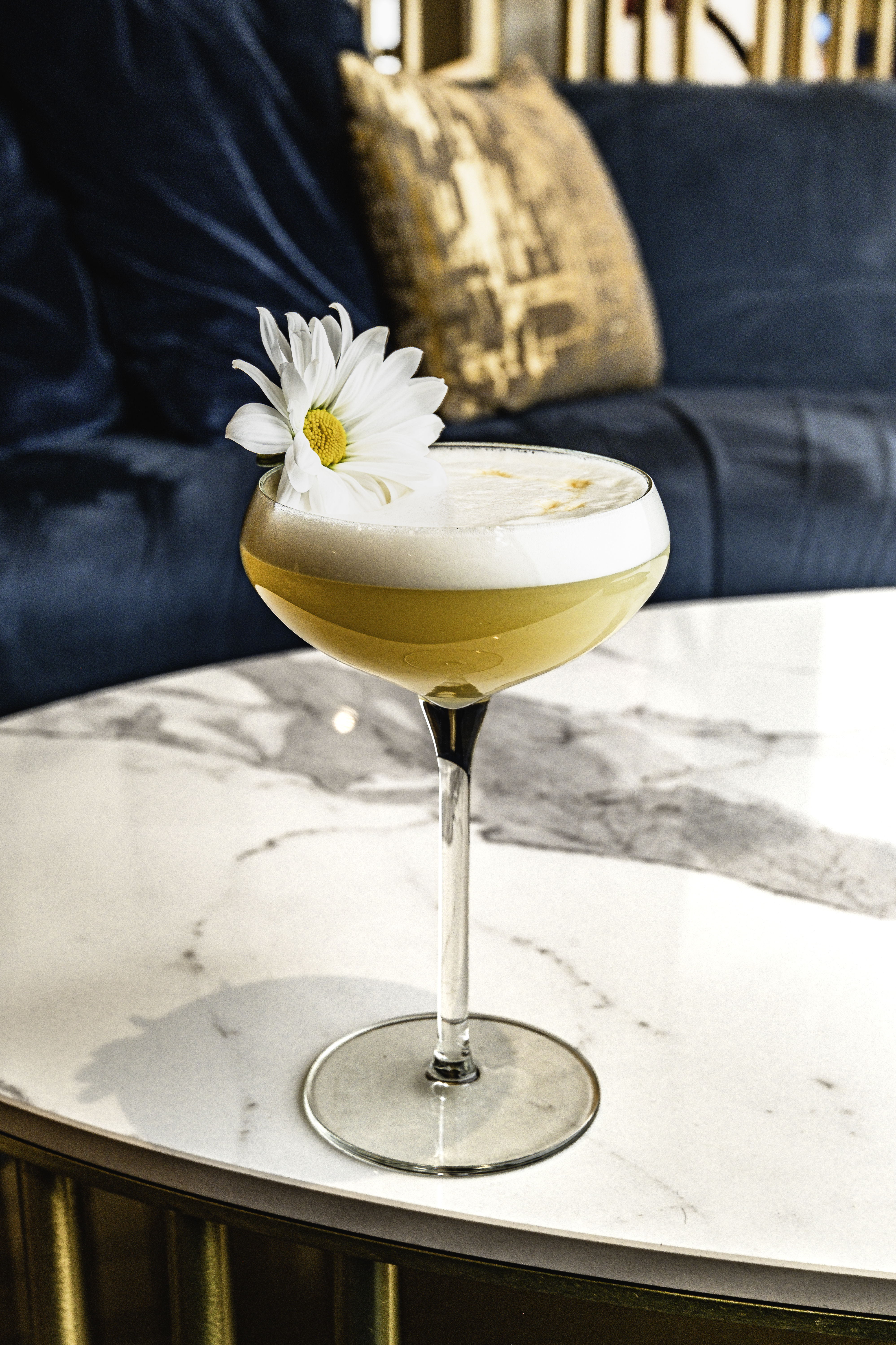 a glass of wine sitting on top of a table