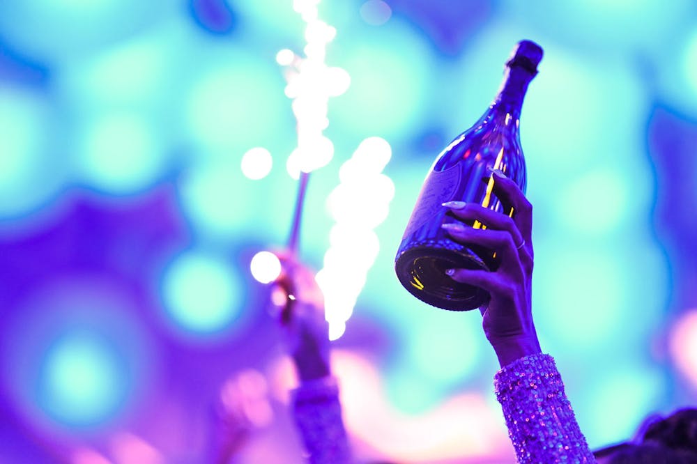 a close up of a woman with a champagne bottle