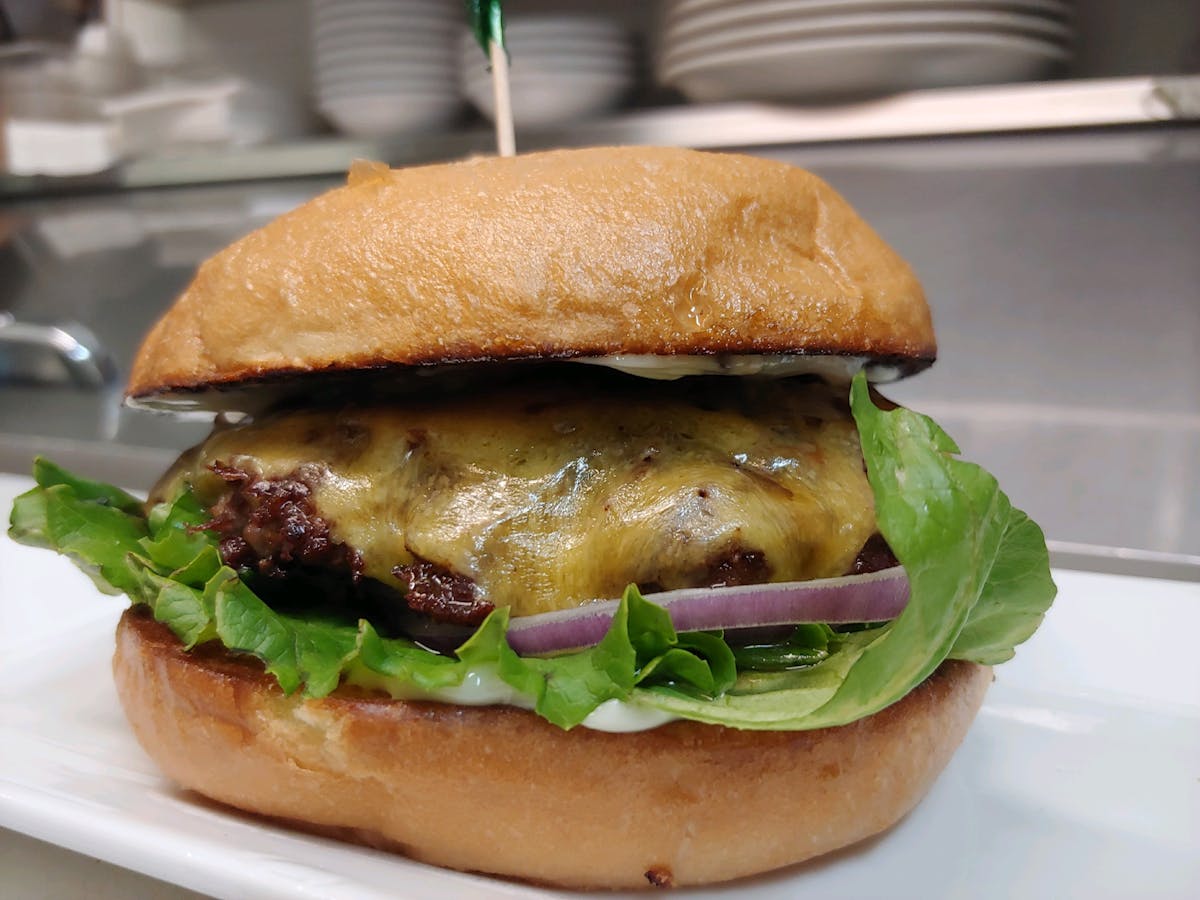 a close up of a burger sitting on top of a table