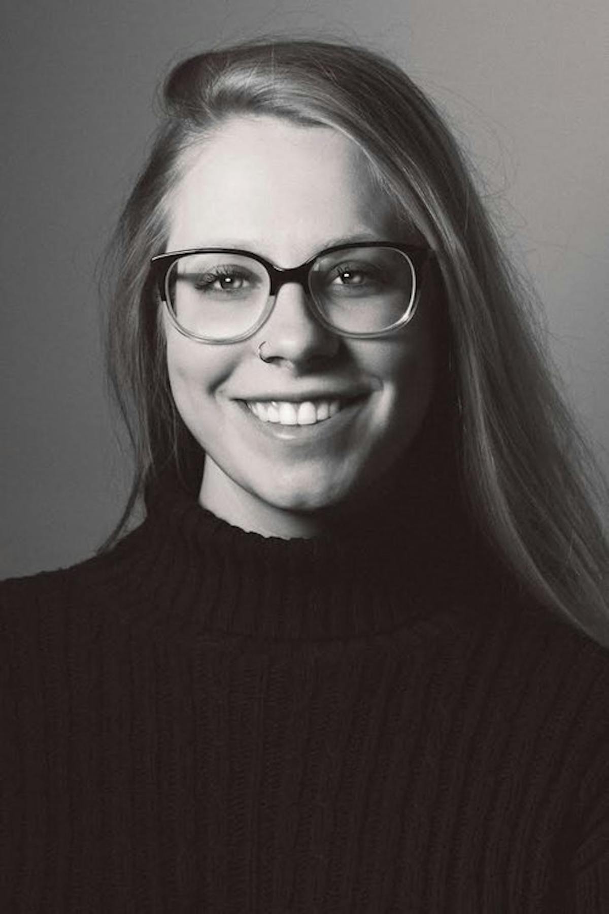 a close up of a person in glasses looking at the camera