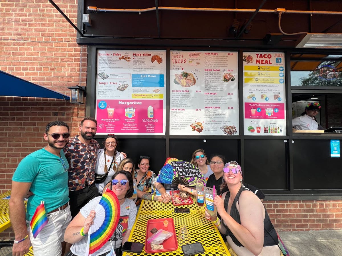 a group of people standing in front of a store