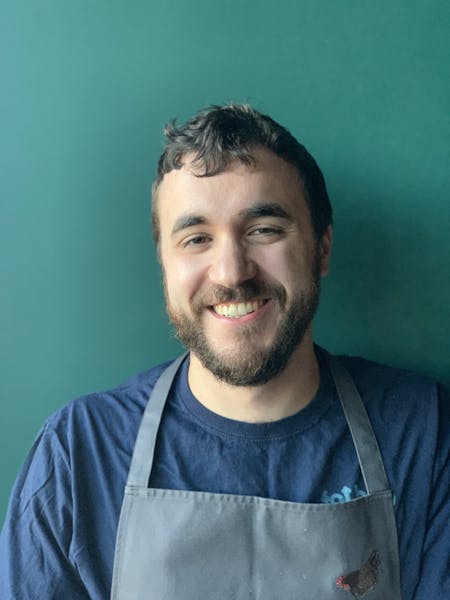 a man who is smiling and looking at the camera