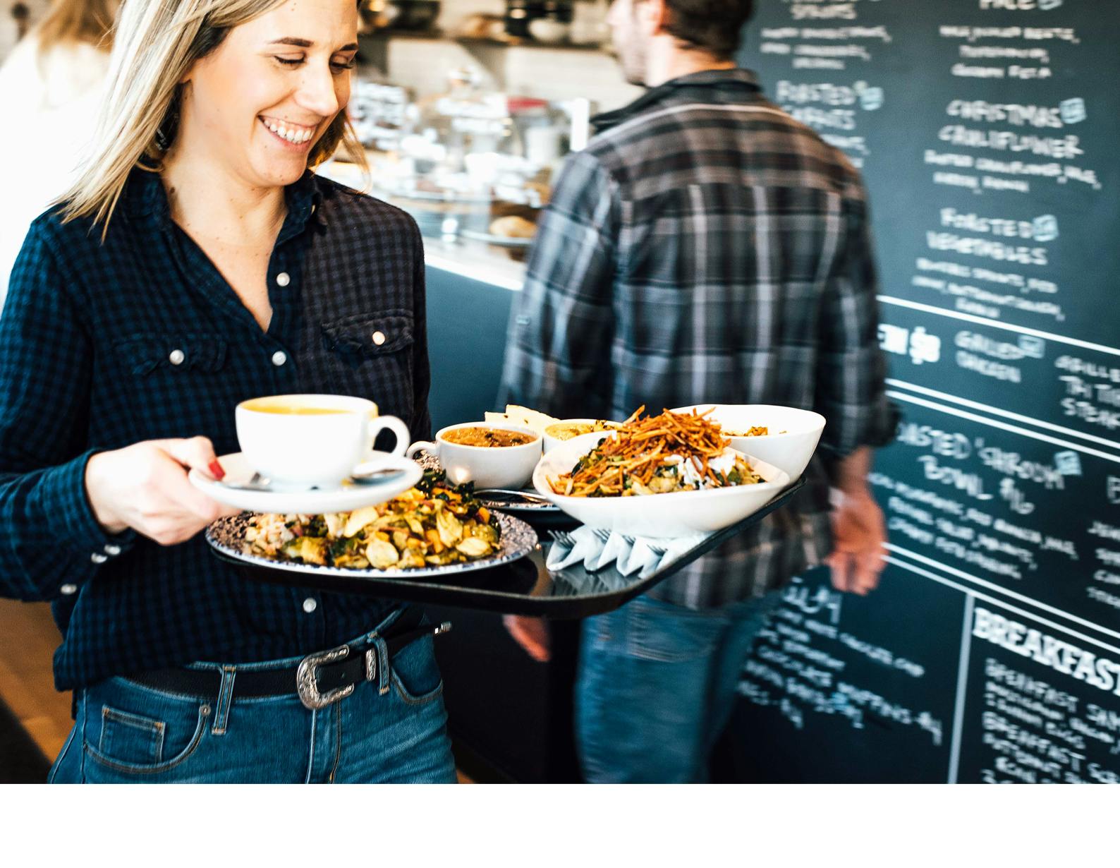 a woman sitting at a table with a plate of food