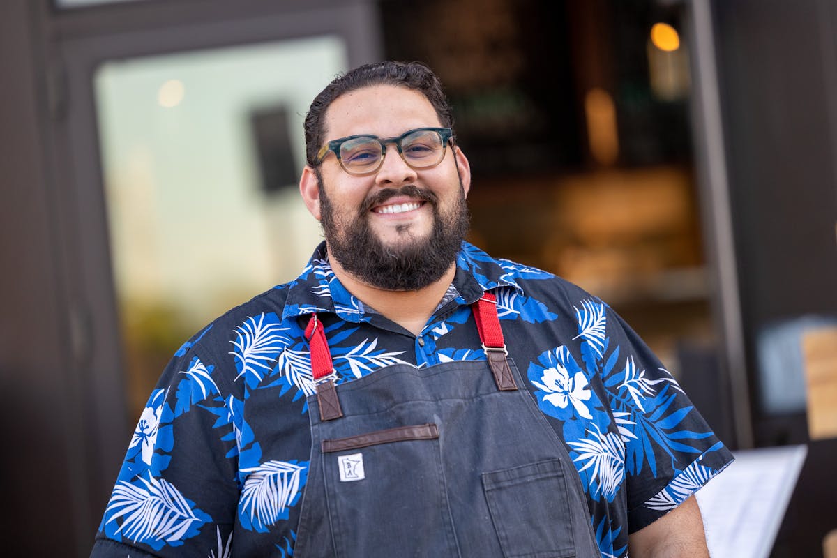 a man wearing glasses and a blue shirt